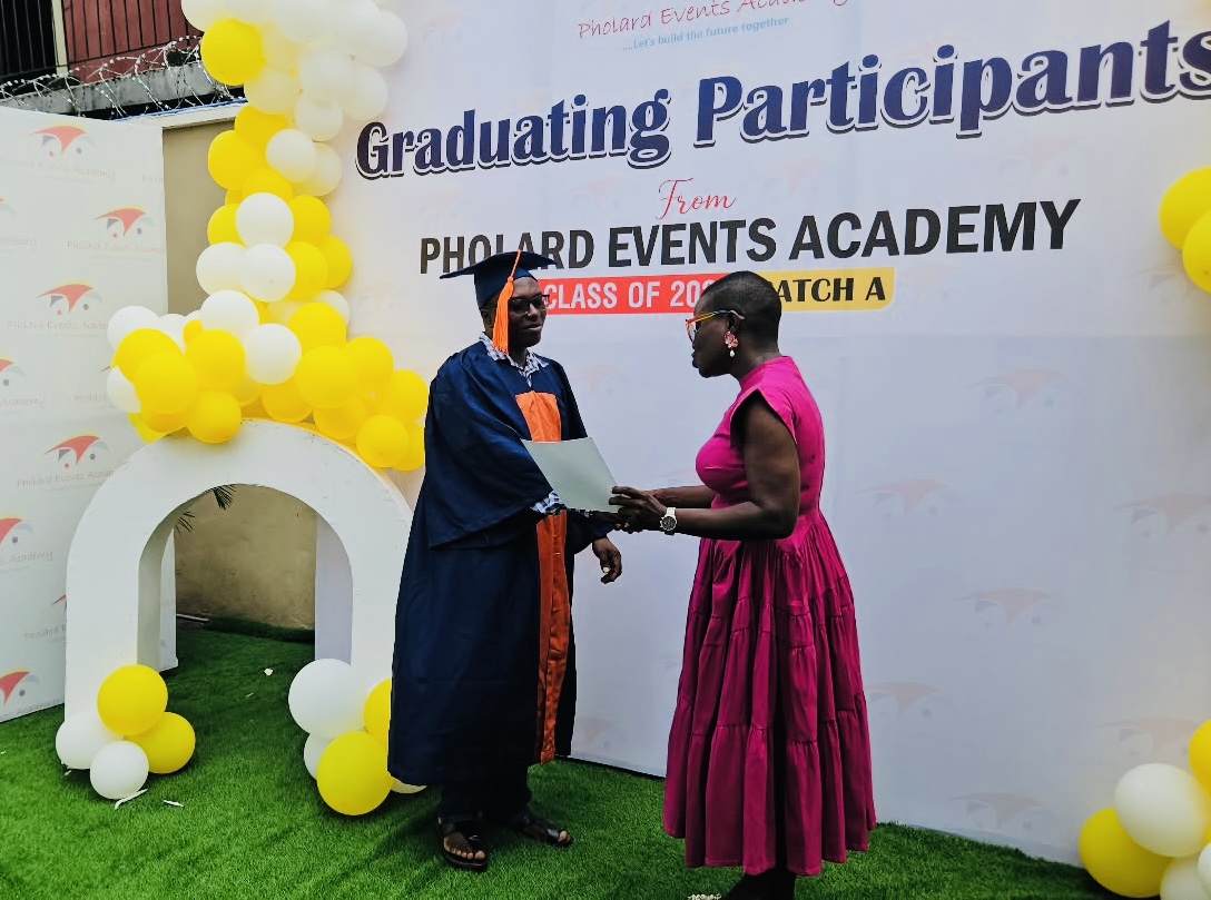 Awarding a certificate to a graduate of Pholard Events Academy